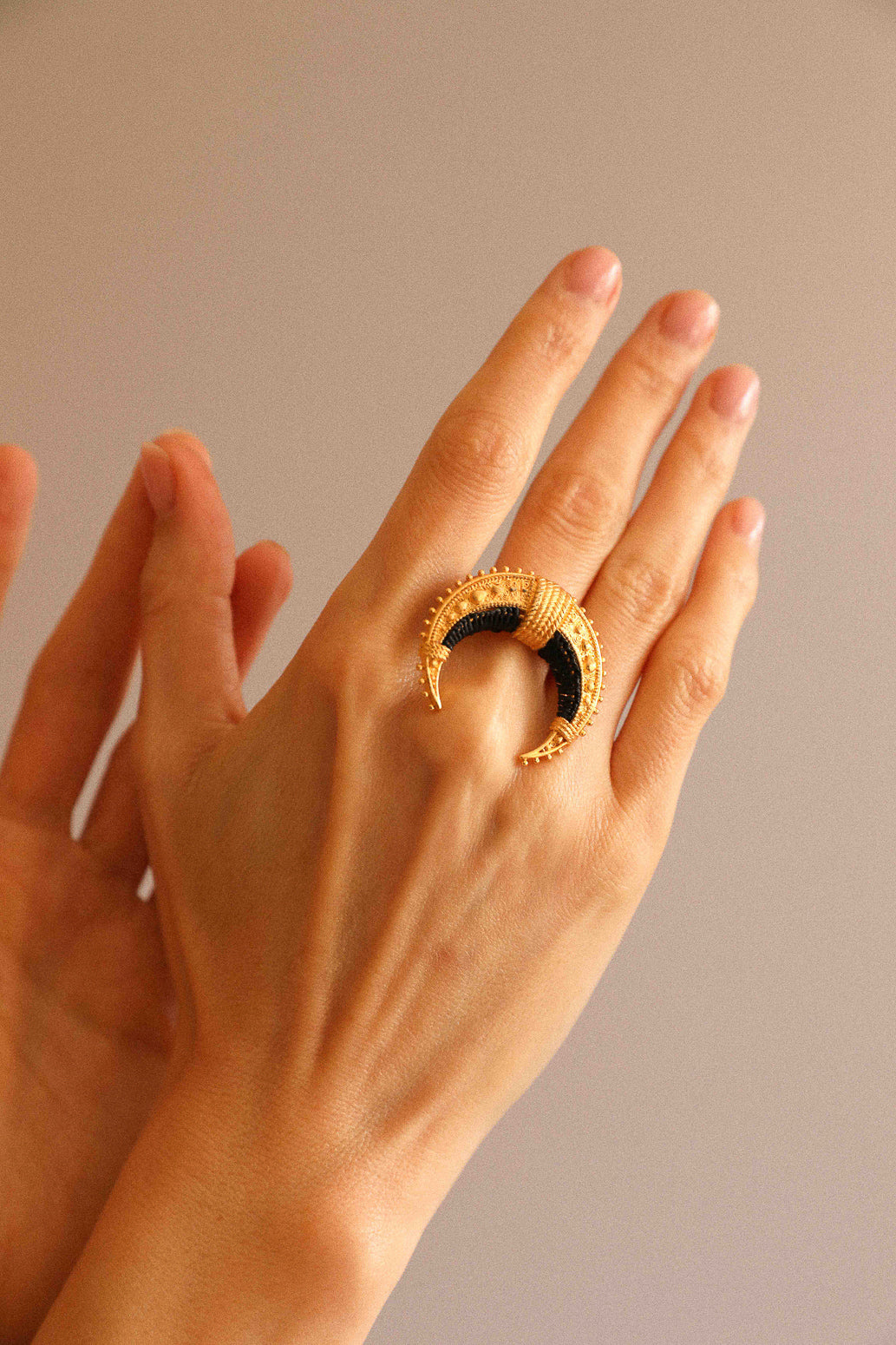 Moun ring, embroidered with black raffia