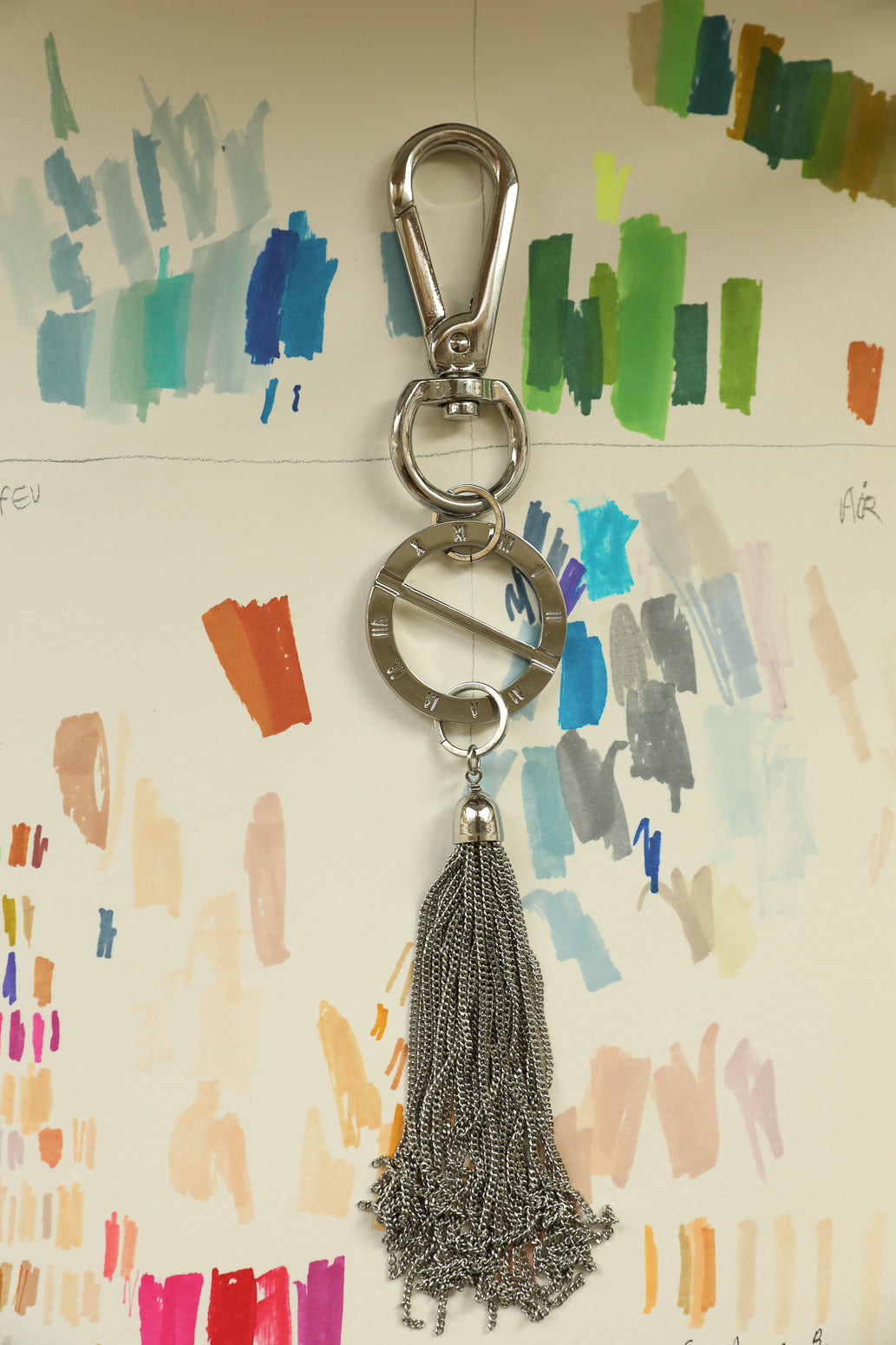AN-NEE rhodium bag charm with rhodium tassel