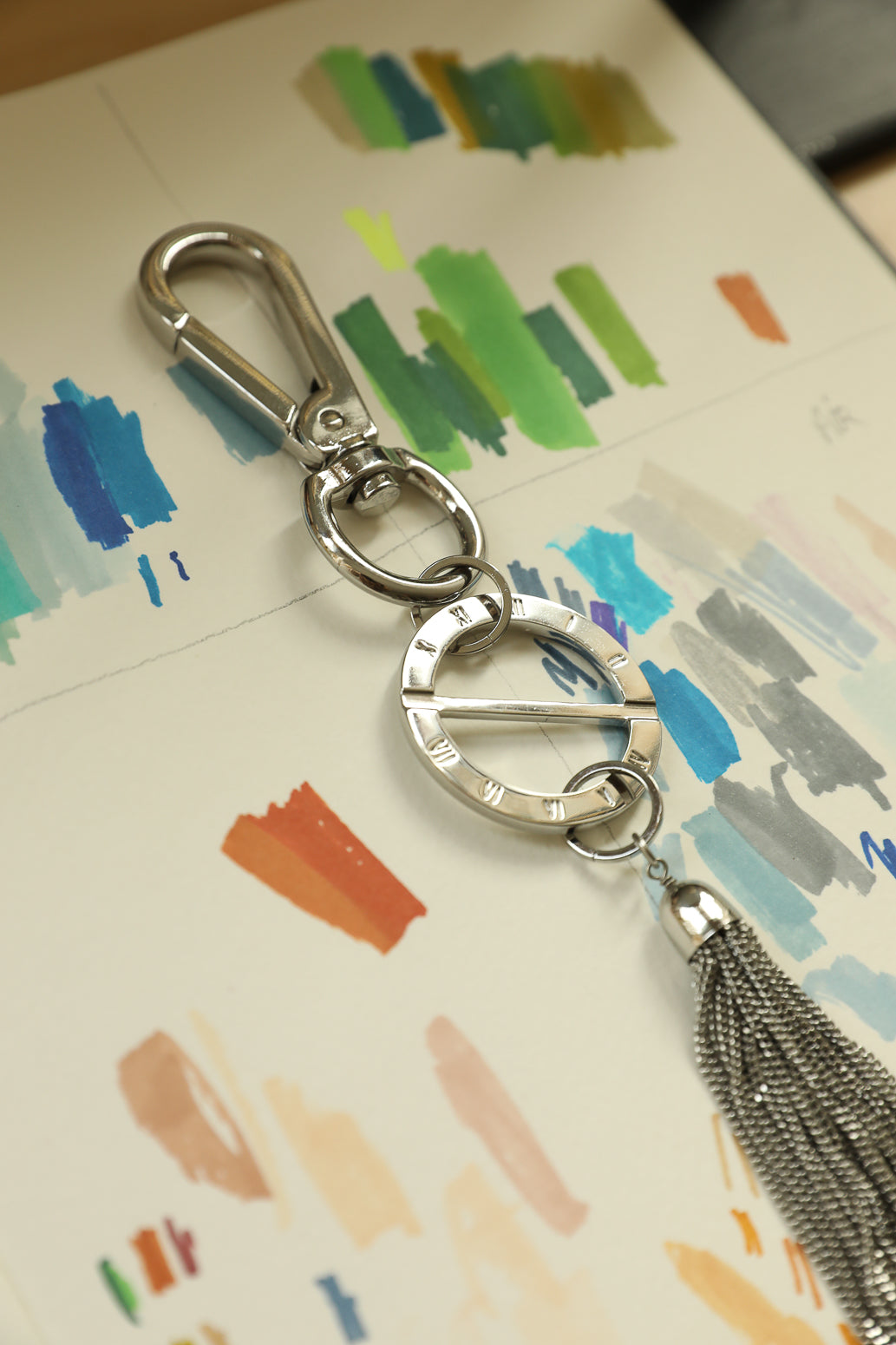 AN-NEE rhodium bag charm with rhodium tassel