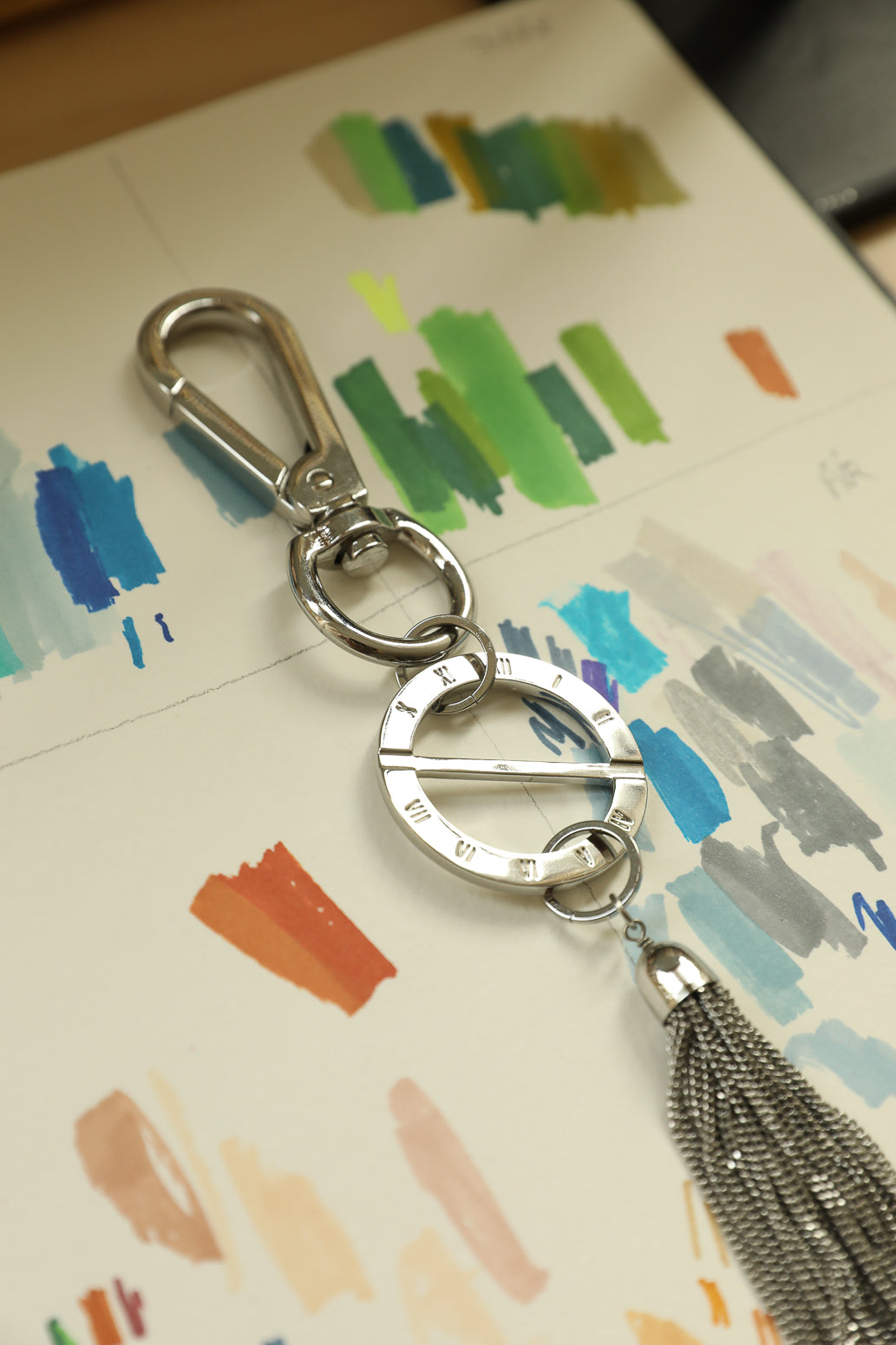 AN-NEE rhodium bag charm with rhodium tassel